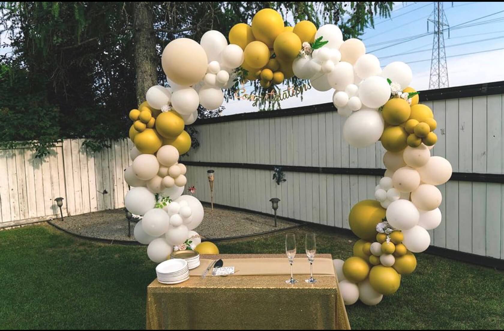 Pastel-themed baby shower with balloon arch and custom backdrop by Mira Creations